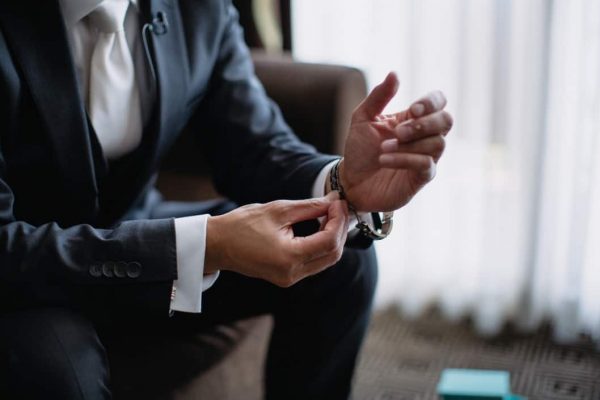 a-business-professional-in-a-suit-and-tie-getting-ready-for-a-work-meeting-and-putting-on-his-wrist_t20_P3PapR