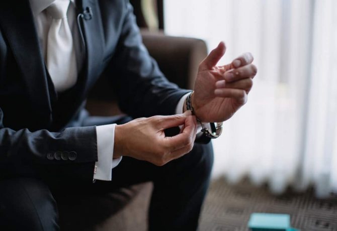 a-business-professional-in-a-suit-and-tie-getting-ready-for-a-work-meeting-and-putting-on-his-wrist_t20_P3PapR